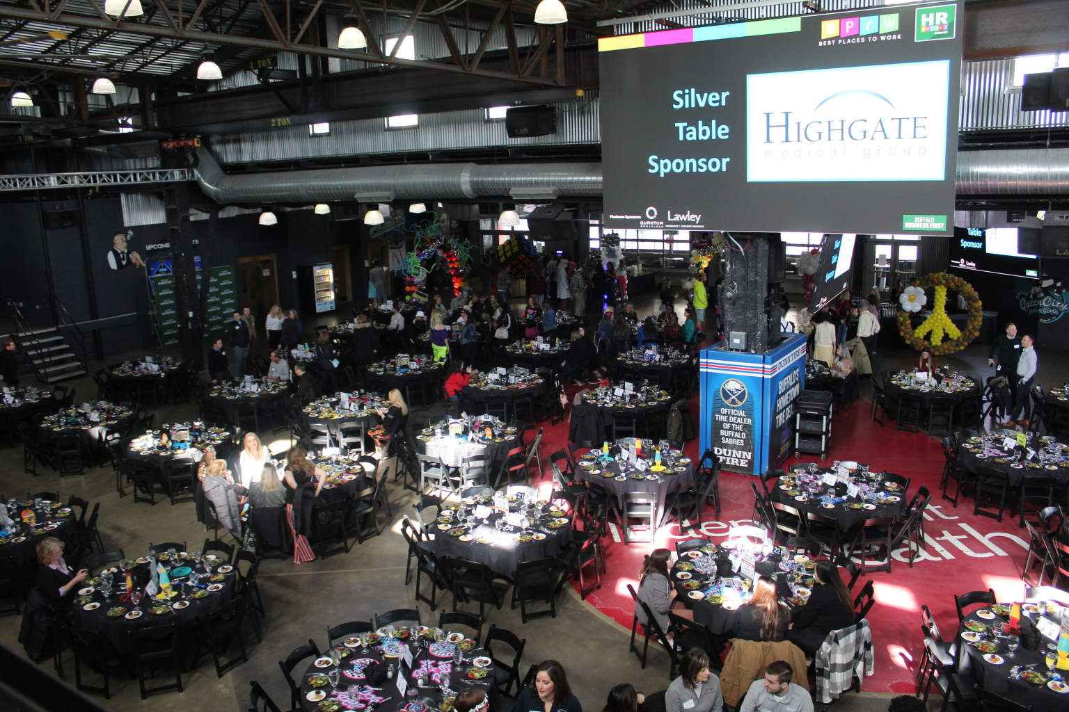 Guests seated across the full facility floor during a large scale event