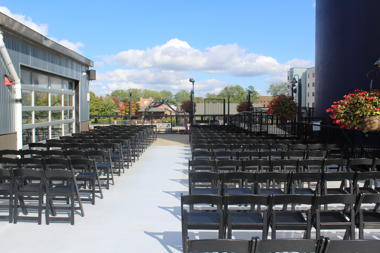 Rows of chairs set for a ceremony on the second story patio