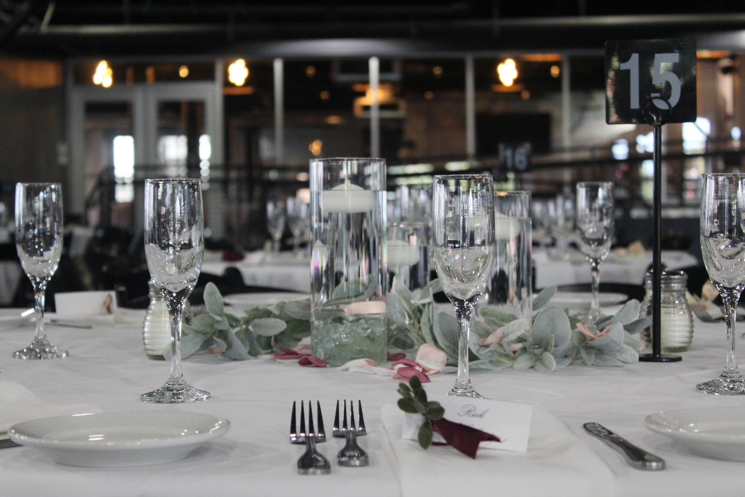 Stemware and folded napkins running down a dressed banquet table