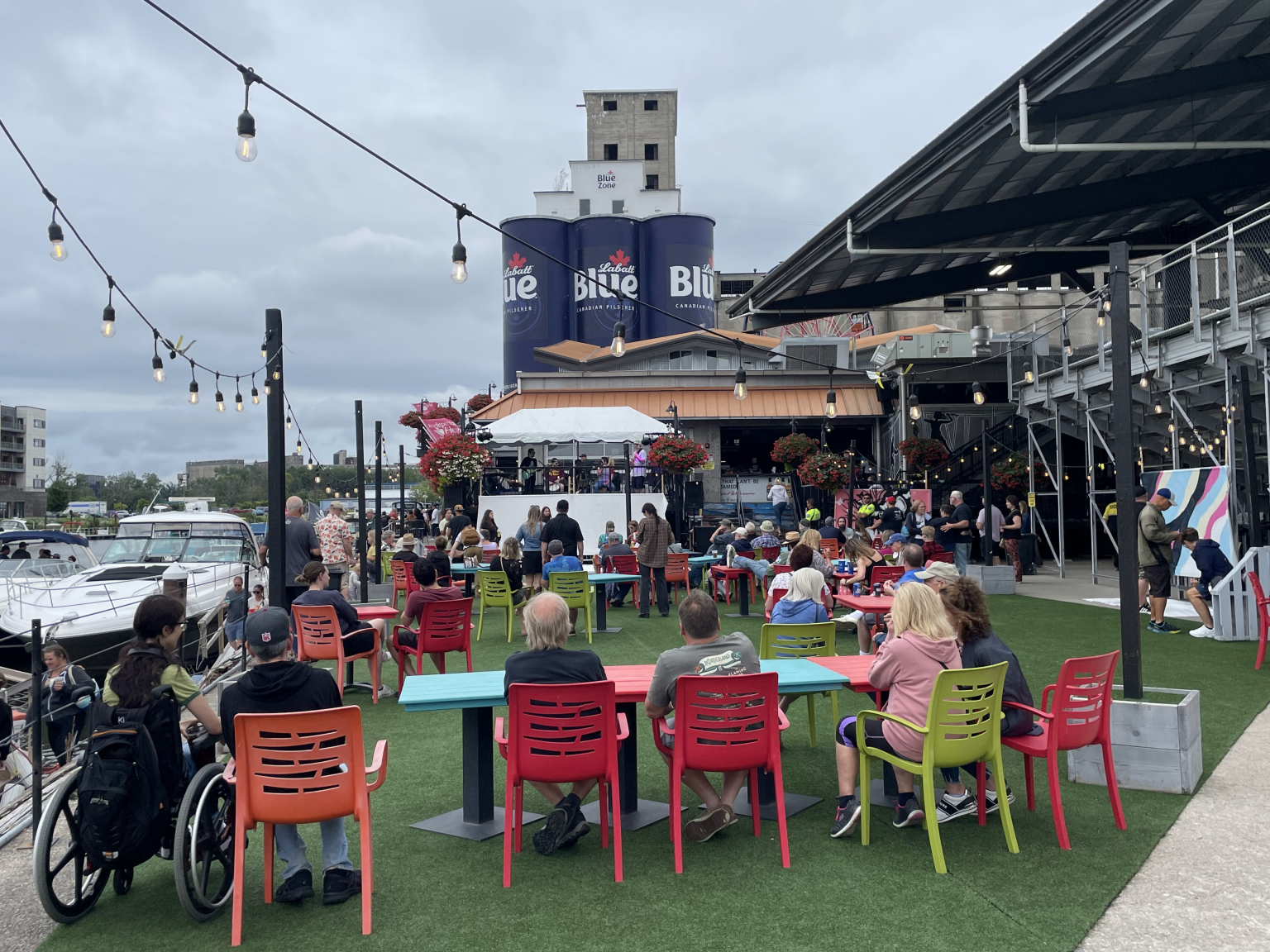 Outdoor patio seating on the turf beside the silos