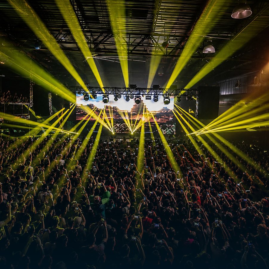 Concert crowd under yellow stage lights at Buffalo RiverWorks