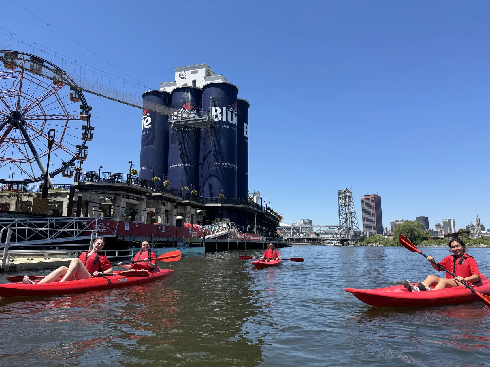 Kayakers paddling past the RiverWorks silos