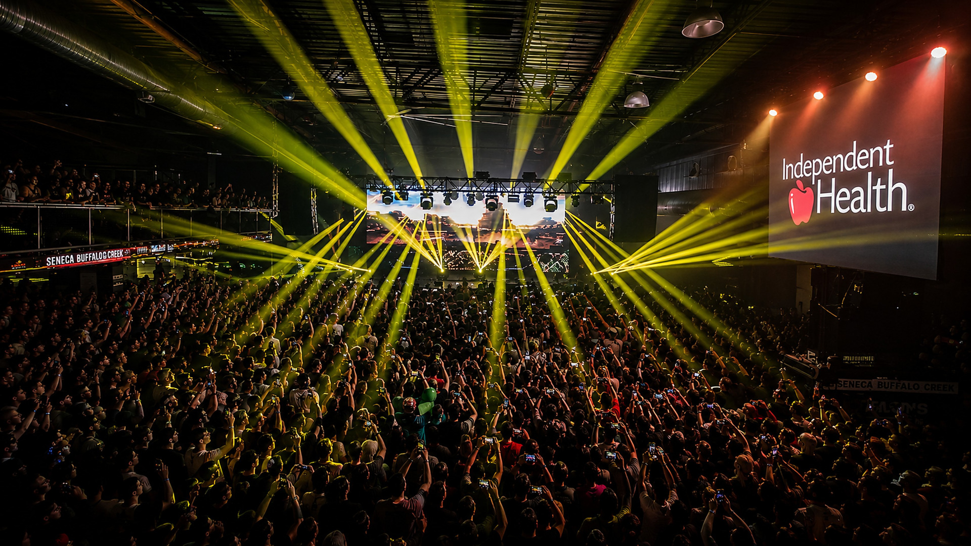A crowd under stage lights at a Buffalo RiverWorks concert