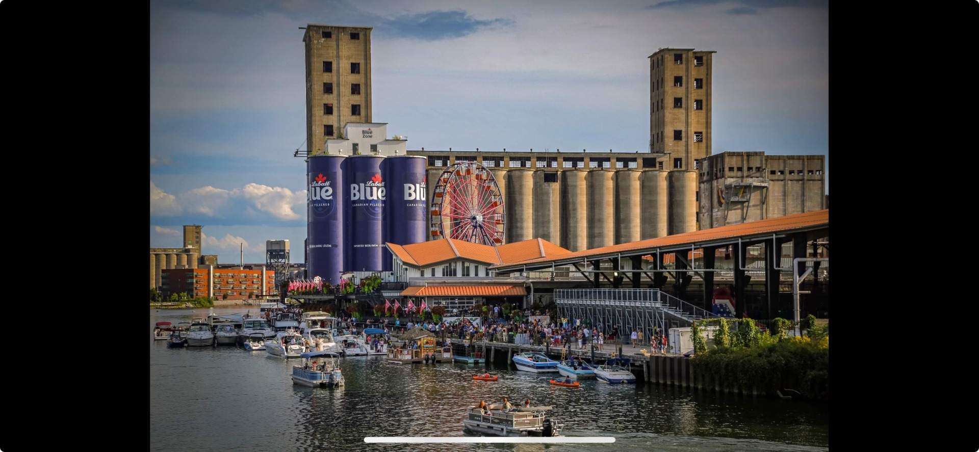 Boats and crowds along the water at Buffalo RiverWorks