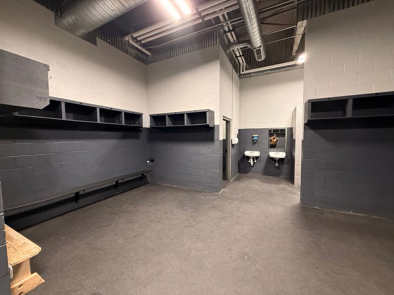 Locker room with dark lockers and sinks.