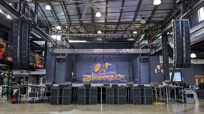 Front of house view of the RiverWorks stage with L-Acoustics line arrays and truss.